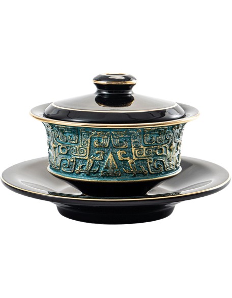 Masterfully handcrafted, hand-painted, gold-plated ceramic bowl with lid featuring a taotie design