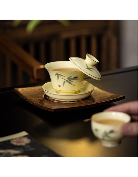 Tea set with three-legged lid that can be suspended and rotated for brewing tea without burning your hands.