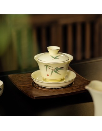 Tea set with three-legged lid that can be suspended and rotated for brewing tea without burning your hands.